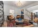 Cozy living room featuring comfortable seating, stylish decor, and open staircase at 8433 Cheverny Dr, Waxhaw, NC 28173