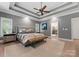 Large main bedroom featuring a tray ceiling, neutral decor, and wood floors at 8433 Cheverny Dr, Waxhaw, NC 28173