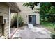 Backyard view features a patio with sliding glass door, shrubbery, and a partial view of the house at 8618 Rittenhouse Cir, Charlotte, NC 28270