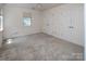 Bedroom features carpet, white walls, multiple closets, and a window providing natural light at 8618 Rittenhouse Cir, Charlotte, NC 28270