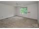 Bedroom with carpet, white walls, ceiling fan, and a window providing natural light at 8618 Rittenhouse Cir, Charlotte, NC 28270