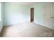 Bright bedroom featuring carpet, a window for natural light, and a door leading to another room at 8618 Rittenhouse Cir, Charlotte, NC 28270