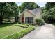 Inviting home with a well-manicured lawn and a long driveway, surrounded by lush trees at 8618 Rittenhouse Cir, Charlotte, NC 28270