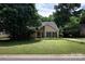 Attractive single-Gathering house with a manicured lawn and mature trees enhancing its curb appeal at 8618 Rittenhouse Cir, Charlotte, NC 28270