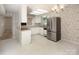 This kitchen features stainless steel appliances, white cabinets, and natural light at 8618 Rittenhouse Cir, Charlotte, NC 28270