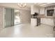Well-lit kitchen with stainless steel appliances, white cabinets, and a large sliding glass door at 8618 Rittenhouse Cir, Charlotte, NC 28270