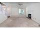 Bright and airy living room with a fireplace, large window, and a ceiling fan at 8618 Rittenhouse Cir, Charlotte, NC 28270