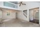 Bright living room with a chandelier, ceiling fan and a view of a second-story balcony at 8618 Rittenhouse Cir, Charlotte, NC 28270