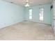 Big main bedroom featuring carpet, light-blue walls, ceiling fan, and natural light from the windows at 8618 Rittenhouse Cir, Charlotte, NC 28270