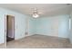 Spacious main bedroom with carpet, light-blue walls, a ceiling fan, and multiple doors at 8618 Rittenhouse Cir, Charlotte, NC 28270