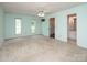 Large main bedroom with carpet, light-green walls, windows, and access to bathroom at 8618 Rittenhouse Cir, Charlotte, NC 28270