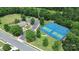 Aerial view of a tennis court and clubhouse offering recreational opportunities and social gathering spaces for residents at 8722 Heron Glen Dr, Charlotte, NC 28269