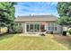 Expansive backyard with outdoor seating and lush landscaping at 8722 Heron Glen Dr, Charlotte, NC 28269