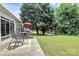 Spacious backyard featuring a cozy patio and outdoor seating surrounded by trees at 8722 Heron Glen Dr, Charlotte, NC 28269