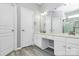 Bright bathroom featuring a vanity with storage, a large mirror, and a view of the shower at 8722 Heron Glen Dr, Charlotte, NC 28269
