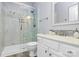 Updated bathroom featuring a glass shower, tiled walls, and modern vanity at 8722 Heron Glen Dr, Charlotte, NC 28269