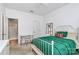 Bright bedroom featuring a white bed frame, a green comforter, and natural light from a window at 8722 Heron Glen Dr, Charlotte, NC 28269
