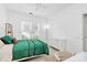 Bright bedroom featuring a white bed frame, a green comforter, and natural light from a window at 8722 Heron Glen Dr, Charlotte, NC 28269