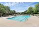 A refreshing community pool with lounge chairs under a bright sky, surrounded by lush greenery creating a resort-like atmosphere at 8722 Heron Glen Dr, Charlotte, NC 28269
