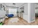 Open dining area with hardwood floors, natural light from the windows, and a view of the kitchen at 8722 Heron Glen Dr, Charlotte, NC 28269