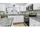 Close-up view of the kitchen featuring granite counters and stainless steel appliances at 8722 Heron Glen Dr, Charlotte, NC 28269