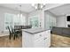 Island in kitchen with granite counter open to dining and living spaces at 8722 Heron Glen Dr, Charlotte, NC 28269