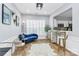 Bright and airy living room with hardwood floors, a blue chaise lounge, and ample natural light at 8722 Heron Glen Dr, Charlotte, NC 28269