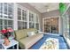Relaxing sunroom boasts plenty of natural light, comfortable seating, and sliding door at 8722 Heron Glen Dr, Charlotte, NC 28269