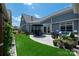 Expansive backyard with a patio, dining area, lounge seating, privacy fence and well-maintained artificial grass lawn at 1006 Gradison Dr, Matthews, NC 28104