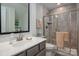 Bathroom featuring a gray vanity with white countertop, a large black framed mirror, and gray tiled shower with glass doors at 1006 Gradison Dr, Matthews, NC 28104
