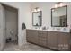 Bathroom with dual vanities, white countertops, and tile flooring, offering ample space and modern amenities at 1006 Gradison Dr, Matthews, NC 28104