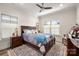 Comfortable bedroom features a ceiling fan, a bed with floral bedding, and natural light at 1006 Gradison Dr, Matthews, NC 28104