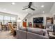 Spacious bonus room with a ceiling fan, large TV, comfortable seating, and ample natural light at 1006 Gradison Dr, Matthews, NC 28104
