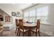 Bright dining area features a wood table, matching chairs, and a large window with natural light at 1006 Gradison Dr, Matthews, NC 28104
