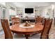 Cozy dining area with a round wood table, chairs, and natural light, perfect for Gathering meals and gatherings at 1006 Gradison Dr, Matthews, NC 28104