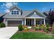 Charming two-story home featuring gray siding, a covered porch, manicured landscaping, and a two-car garage at 1006 Gradison Dr, Matthews, NC 28104