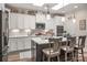 Modern kitchen with white cabinets, center island with seating, and stainless steel appliances at 1006 Gradison Dr, Matthews, NC 28104