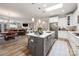 Open kitchen and dining area with an island, stainless appliances, and hardwood floors at 1006 Gradison Dr, Matthews, NC 28104