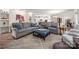 Open-concept living room with lots of seating and decor; flows into the kitchen at 1006 Gradison Dr, Matthews, NC 28104