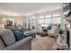 Cozy living room with plush seating, large windows, neutral color palette, and fireplace at 1006 Gradison Dr, Matthews, NC 28104
