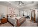 Spacious main bedroom with a bed, end tables, carpet, and barn doors leading to a relaxing sitting room at 1006 Gradison Dr, Matthews, NC 28104