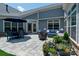 Rear patio features stylish seating and an outdoor dining table and manicured plants, great for backyard entertainment at 1006 Gradison Dr, Matthews, NC 28104