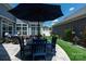 Well designed patio featuring an umbrella, dining table and chair set, and an additional seating area for relaxing at 1006 Gradison Dr, Matthews, NC 28104