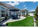 Paver patio features outdoor seating, a patio umbrella, manicured landscaping, and plush artificial turf at 1006 Gradison Dr, Matthews, NC 28104