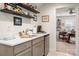 Features a wet bar with modern countertops, sink, and a view of the craft room at 1006 Gradison Dr, Matthews, NC 28104