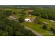 Expansive aerial view of the property showing lush greenery, multiple buildings, and ample land at 1028 Washburn Switch Rd, Shelby, NC 28150
