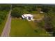 This aerial shows the building with multiple garage doors and ample land space with road access on a sunny day at 1028 Washburn Switch Rd, Shelby, NC 28150