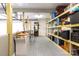 View of the basement, complete with shelving, table, storage, and painted floor at 1028 Washburn Switch Rd, Shelby, NC 28150