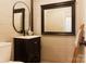 Modern bathroom with dark vanity, decorative mirrors, and neutral walls at 1028 Washburn Switch Rd, Shelby, NC 28150