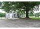 Charming home featuring two garage doors, complemented by a large shade tree at 1028 Washburn Switch Rd, Shelby, NC 28150